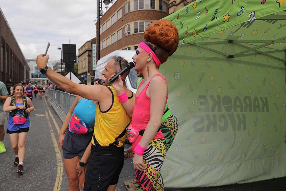 Runners take part in the AJ Bell Great North 10k taking a selfie at the Karaoke Kicks entertainment zone.